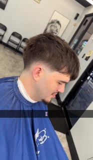 Client with a textured fringe on top and a low fade